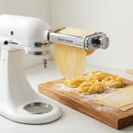 Antree pasta attachment mounted on a mixer with fresh pasta dough.
